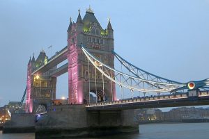 A view of Tower Bridge, lit up in pink.